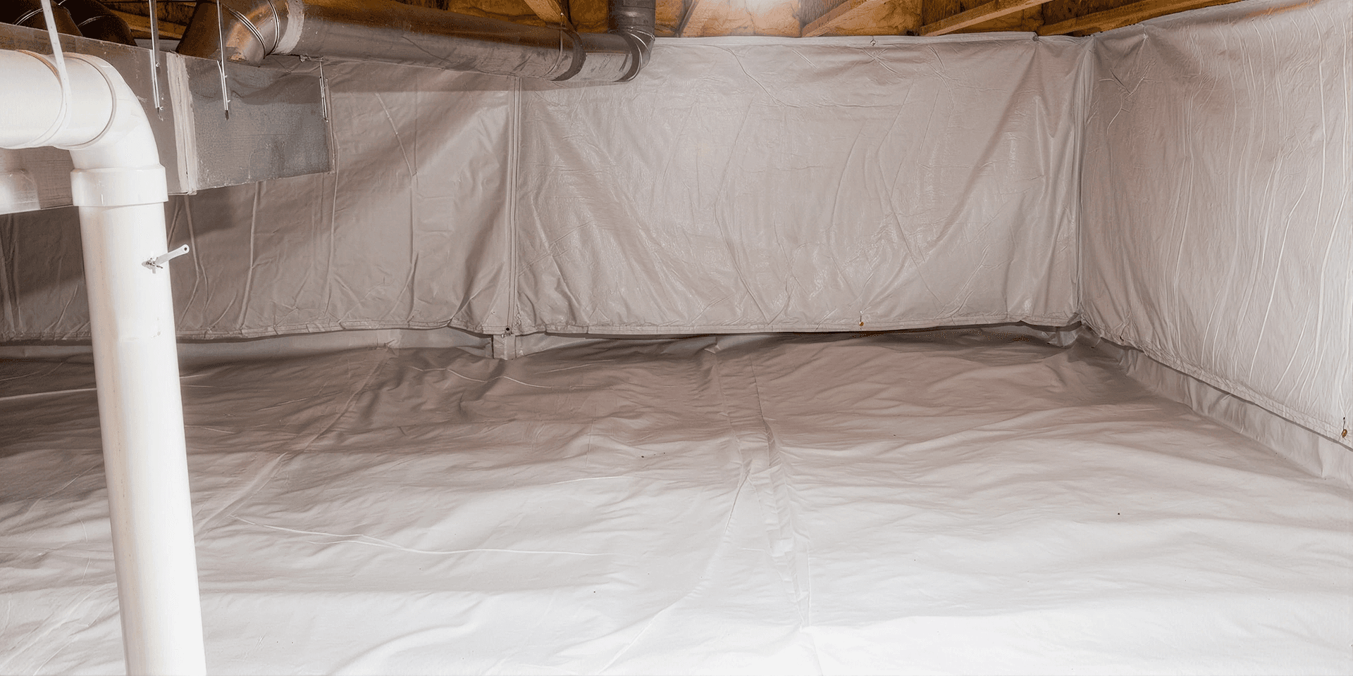 Clean encapsulated crawlspace with a white vapor barrier covering the floor and foundation walls.
