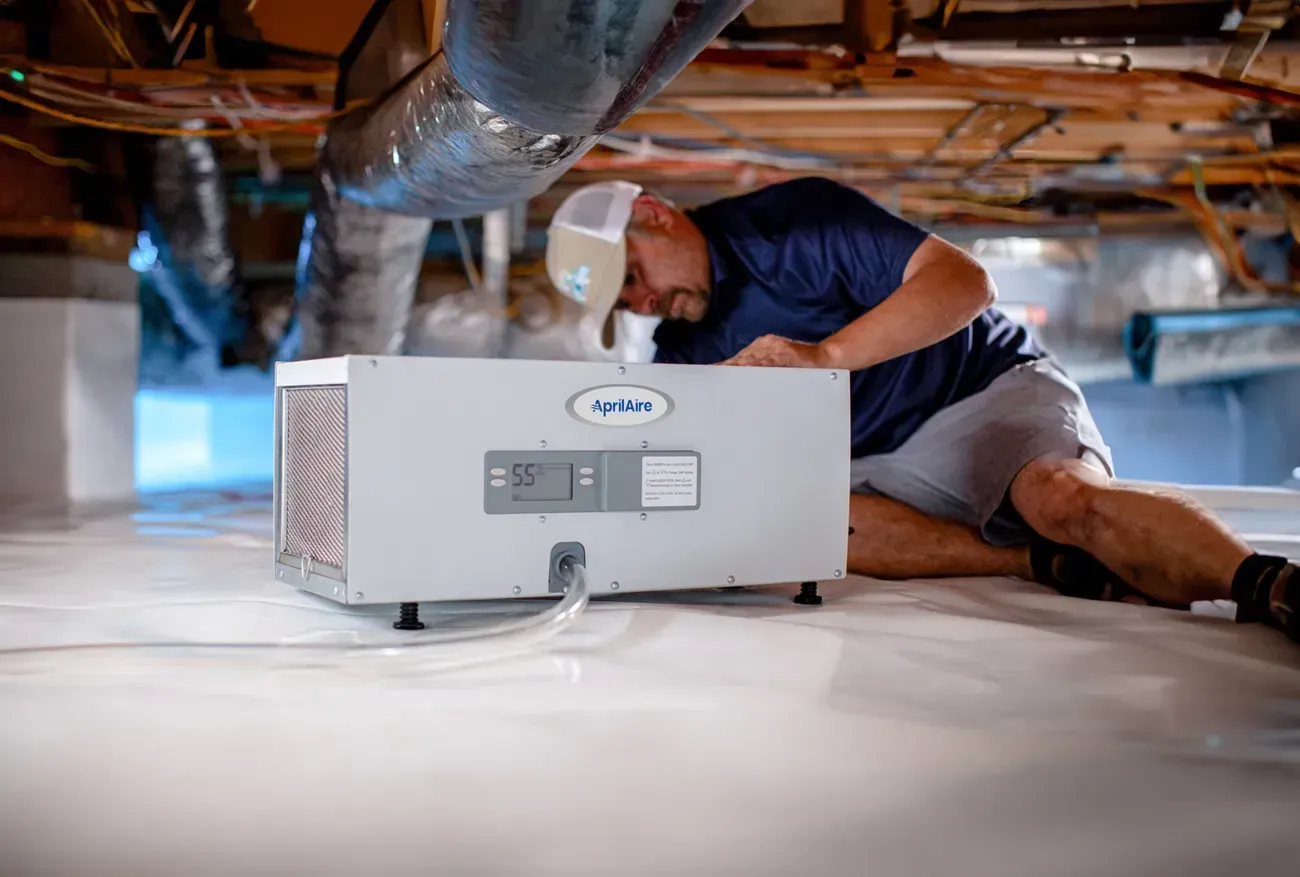 technician-installing-dehumidifier-crawl-space